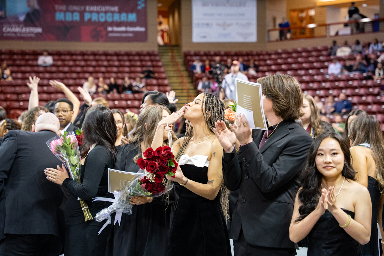 graduate blows a kiss to her family 