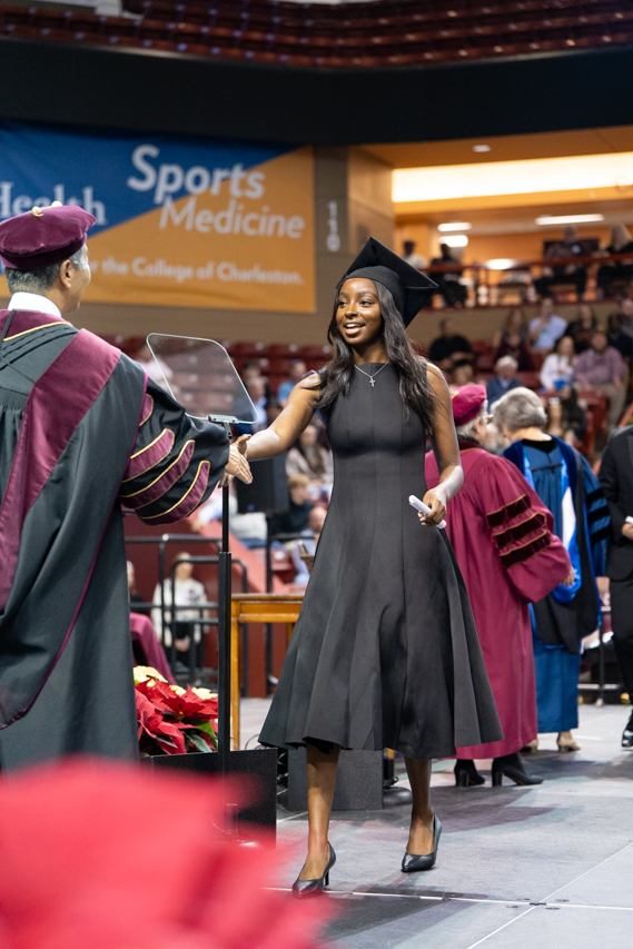 student walks commencement stage 
