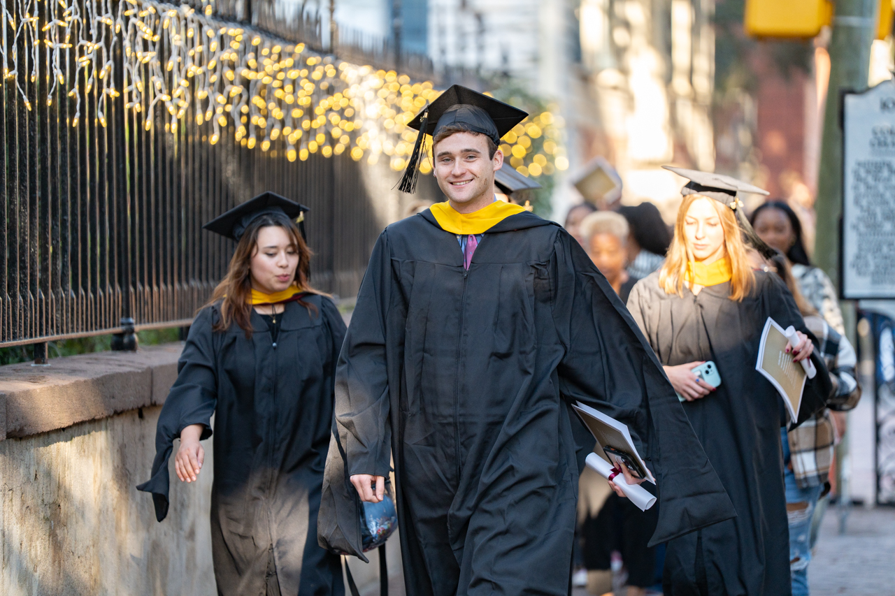 walking to the cistern in cap and gown