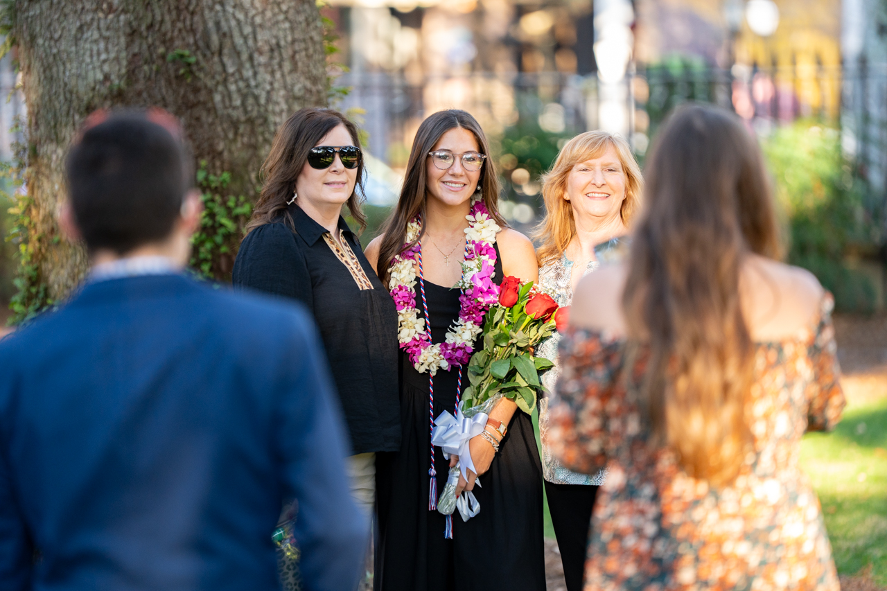 families take photos of their graduates in the Cistern