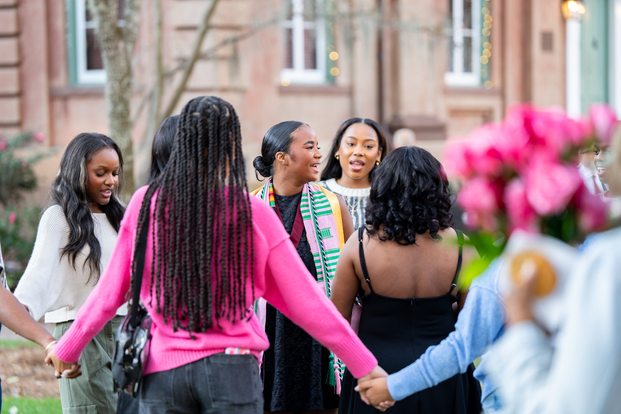 sorority sisters sing and hold hands in the cistern 