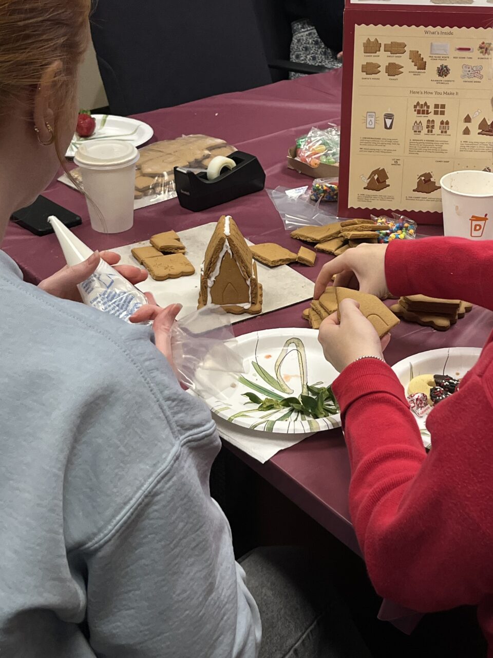 international students make gingerbread houses