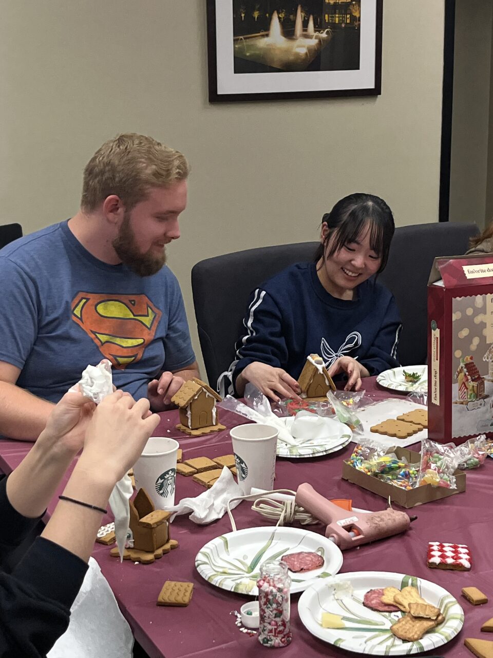 international students make gingerbread houses