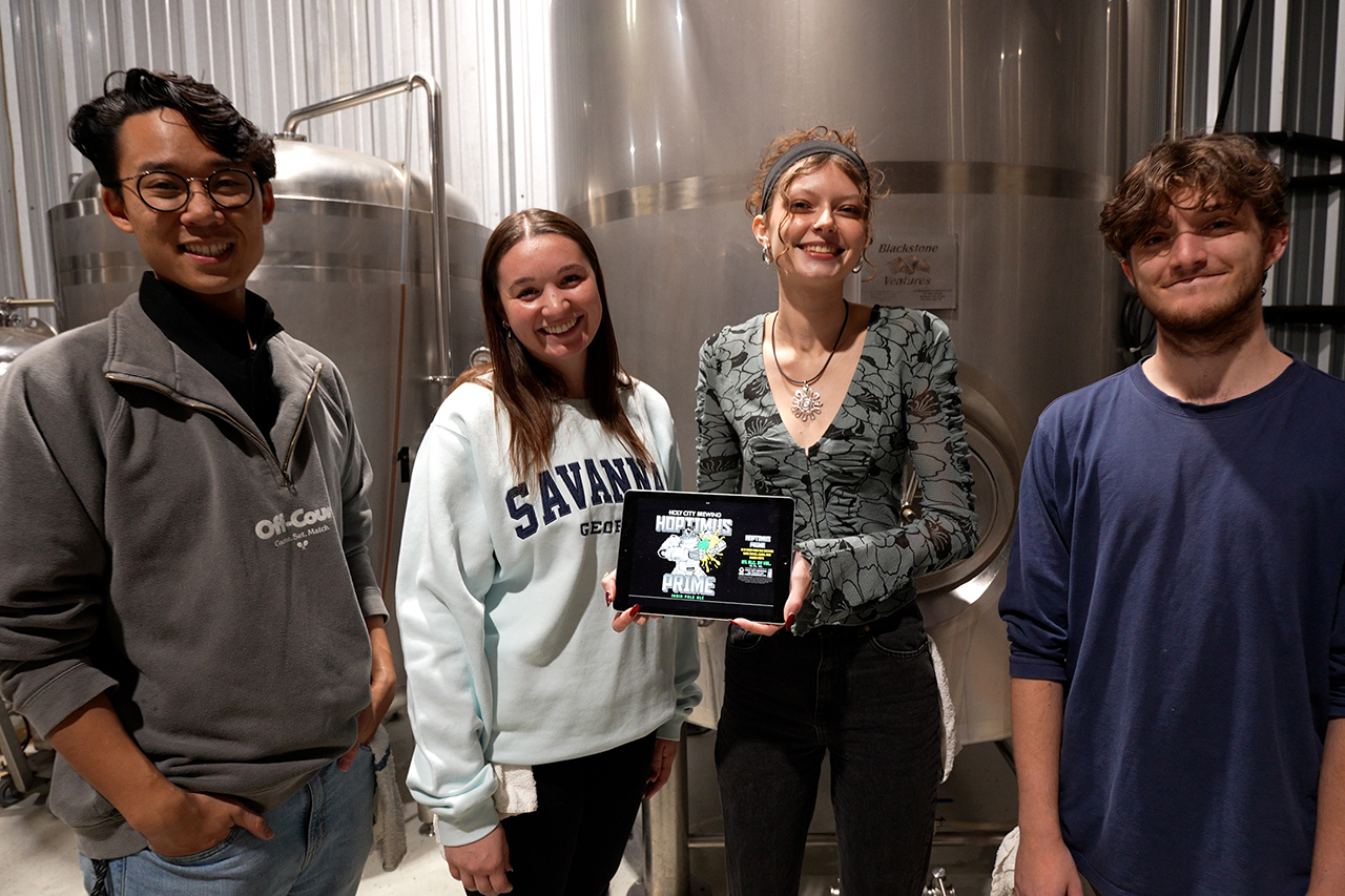 four people standing in a microbrewery