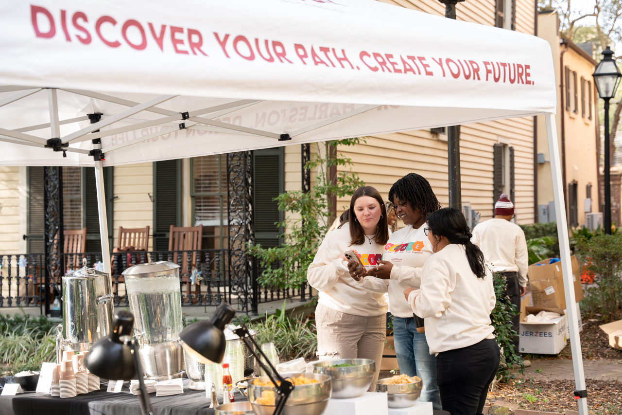 Students talk under awning that reads discover your path. create your future. 