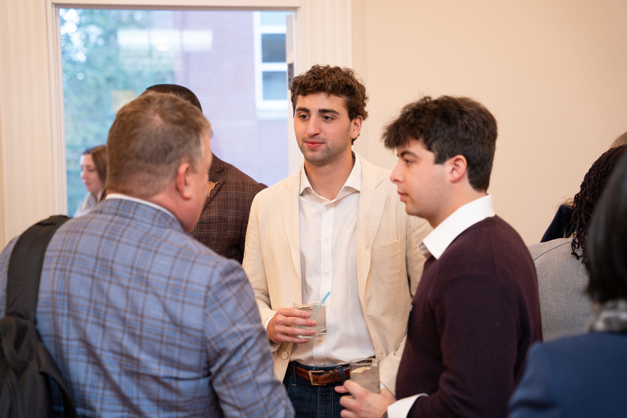 students talk with Board of Trustee members at event 