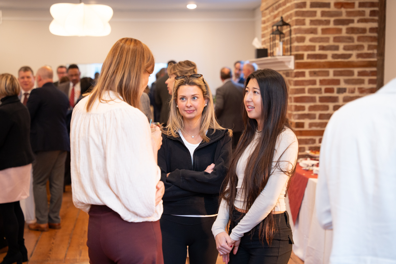 students talk with Board of Trustee members at event 
