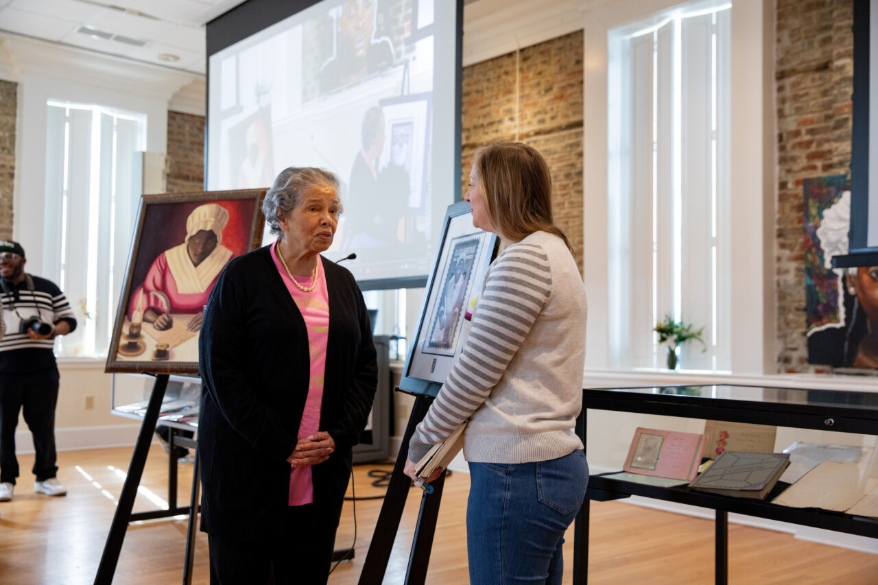 women speak to each other about new stamp