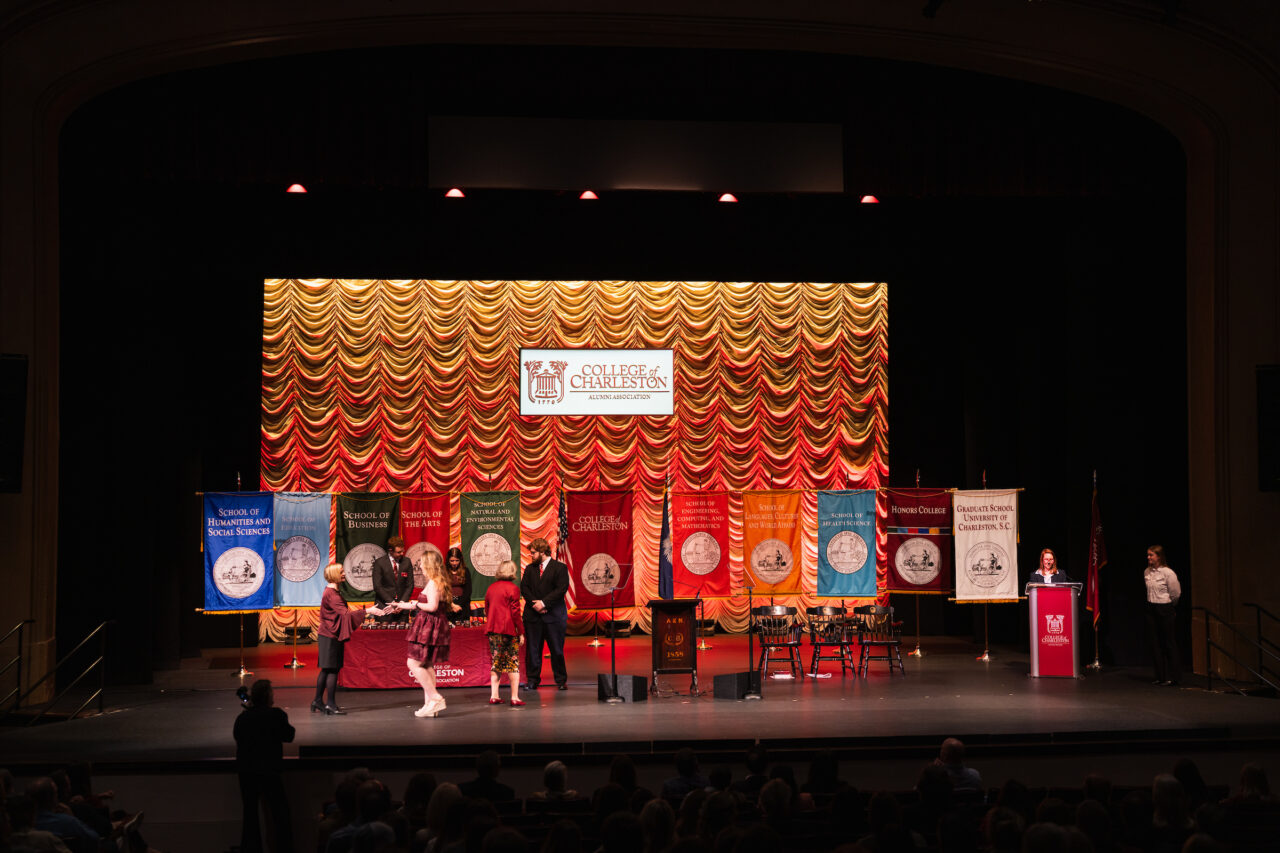 student walks across Sotille stage at ring ceremony 