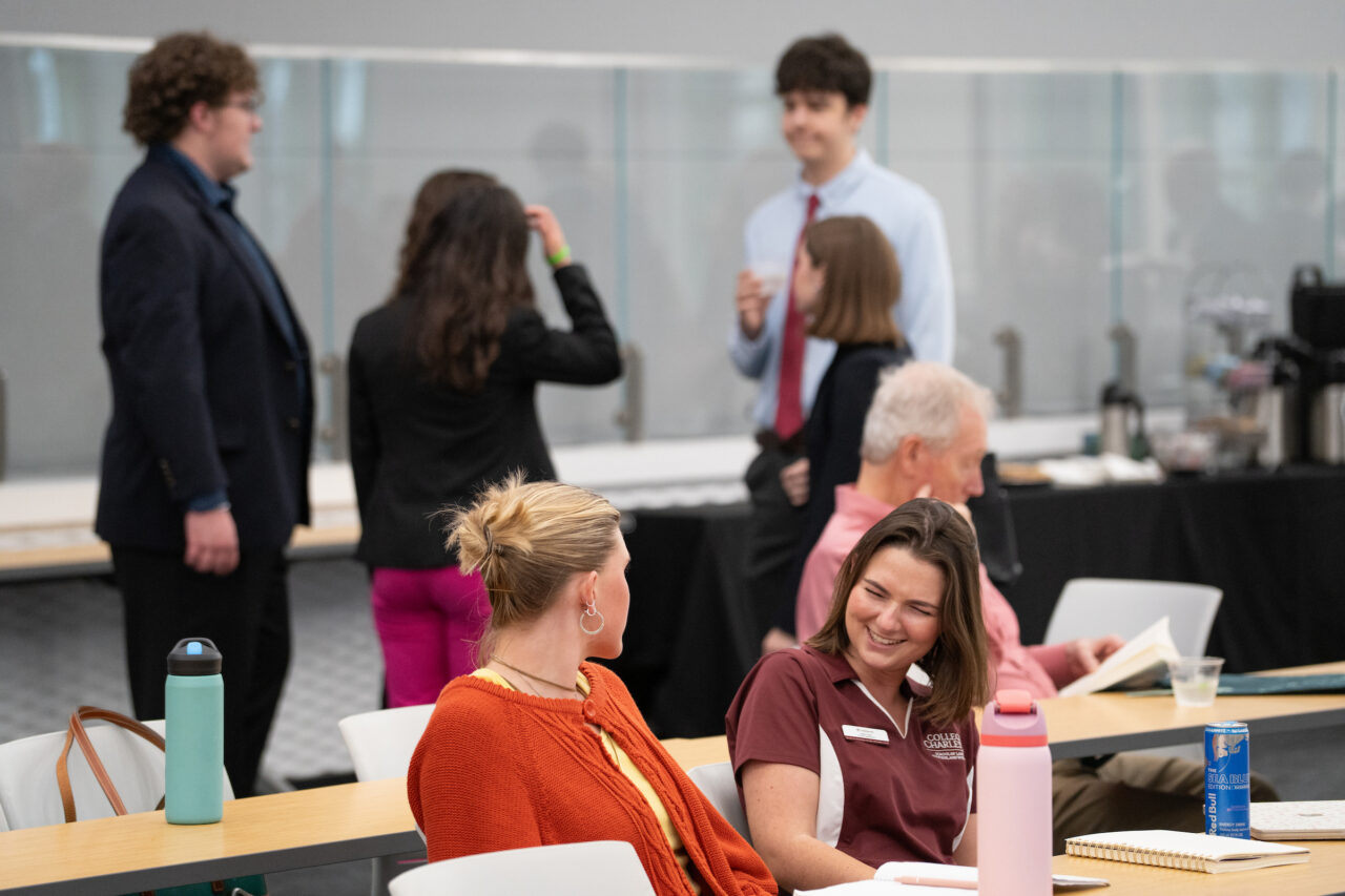students talk before panel
