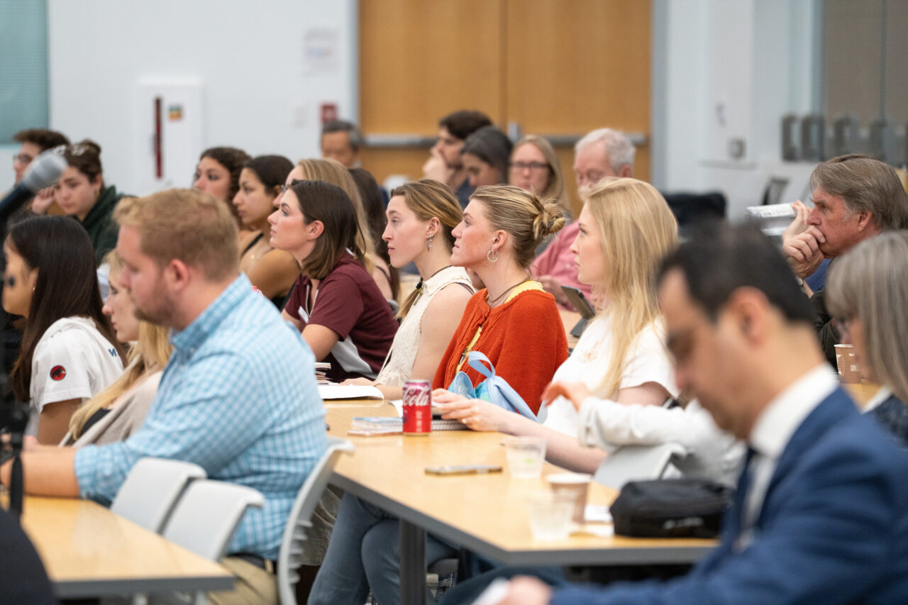 students sit and listen to panel with intent 