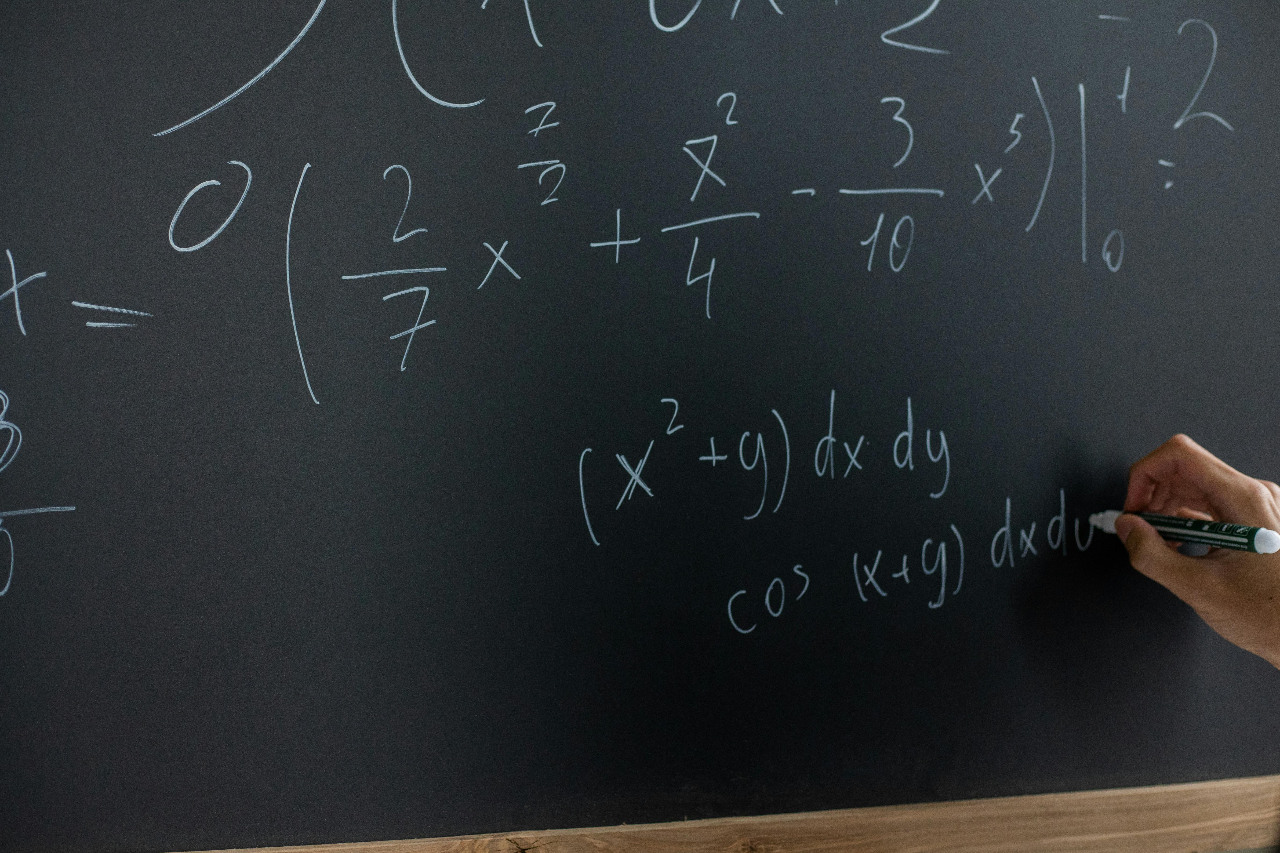 complex math problem written on a chalkboard