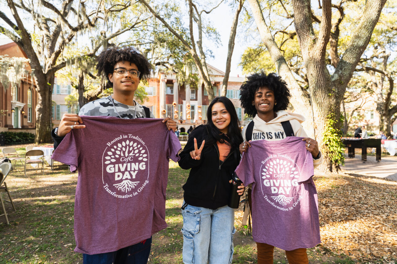 students pose with t-shirts