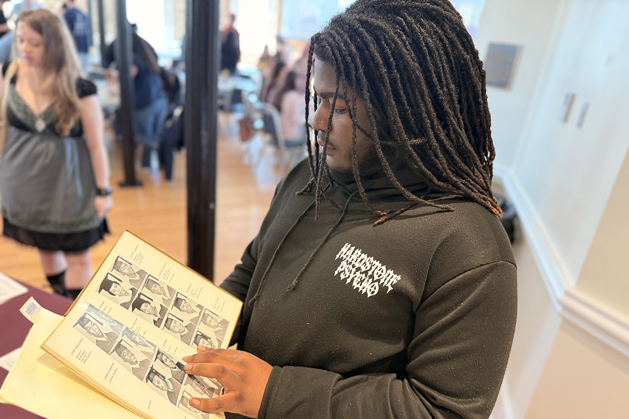 Donte Foxworth looks through an archival yearbook searching for possible family connections.
