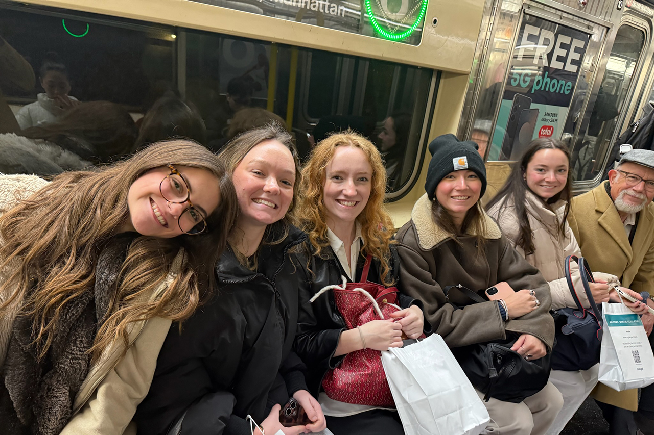 students with their professor on the subway