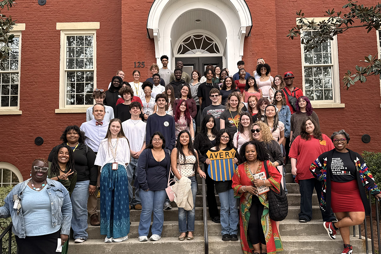 Group of high school students and Avery staff standing in front of the Avery Center for African American History and Culture
