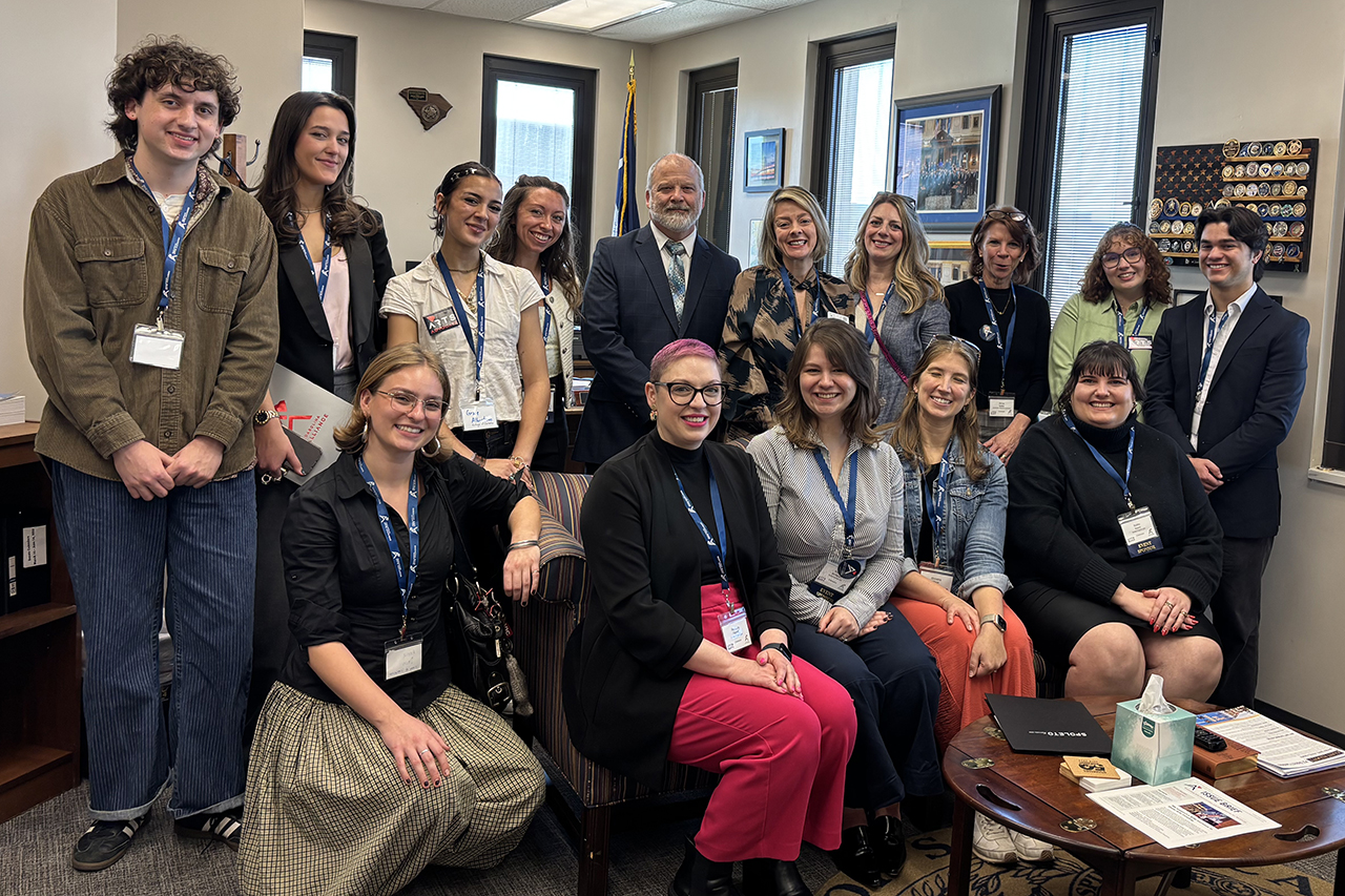 People sitting in group and smiling at camera