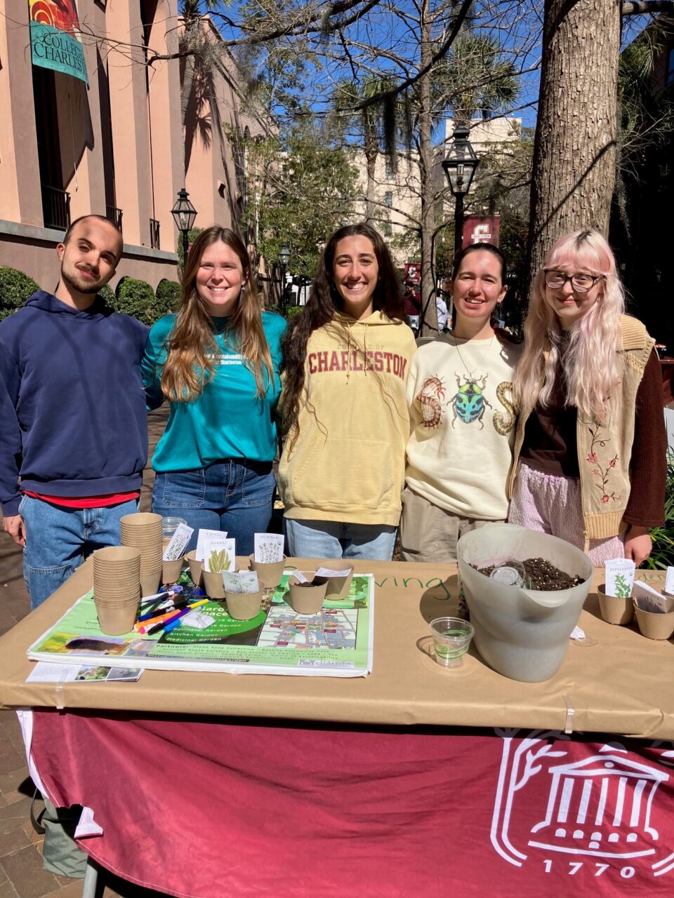 students pose at table