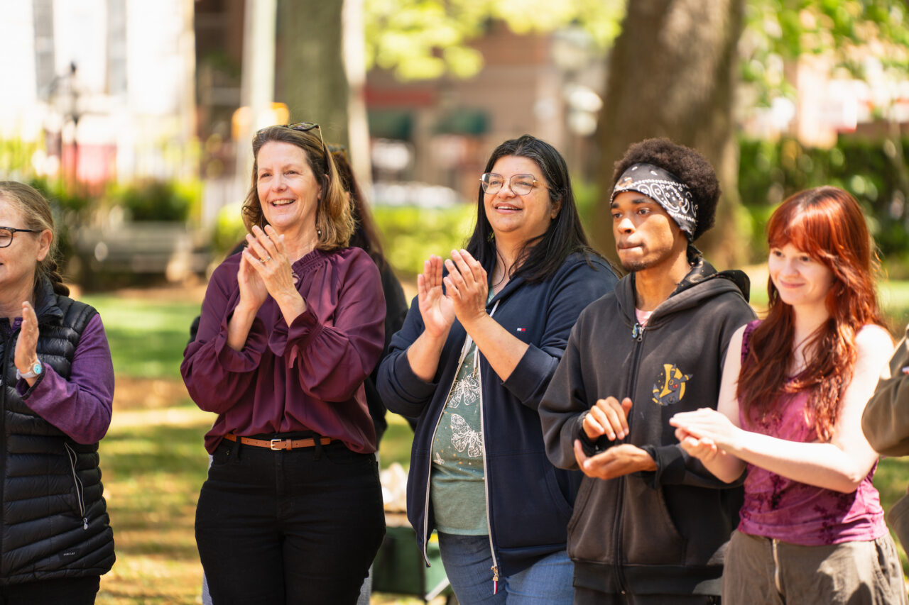 students and faculty clap