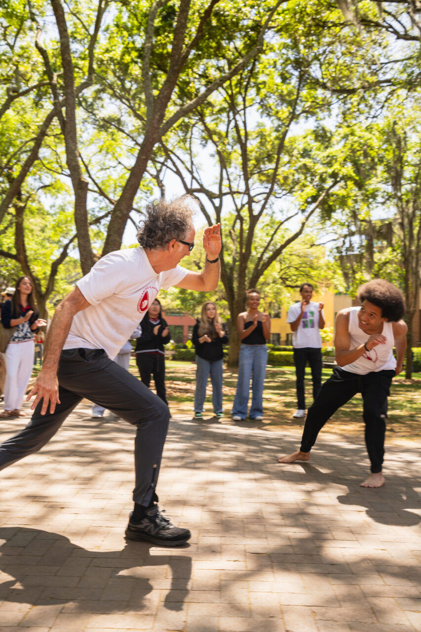 faculty and students perform capoeira