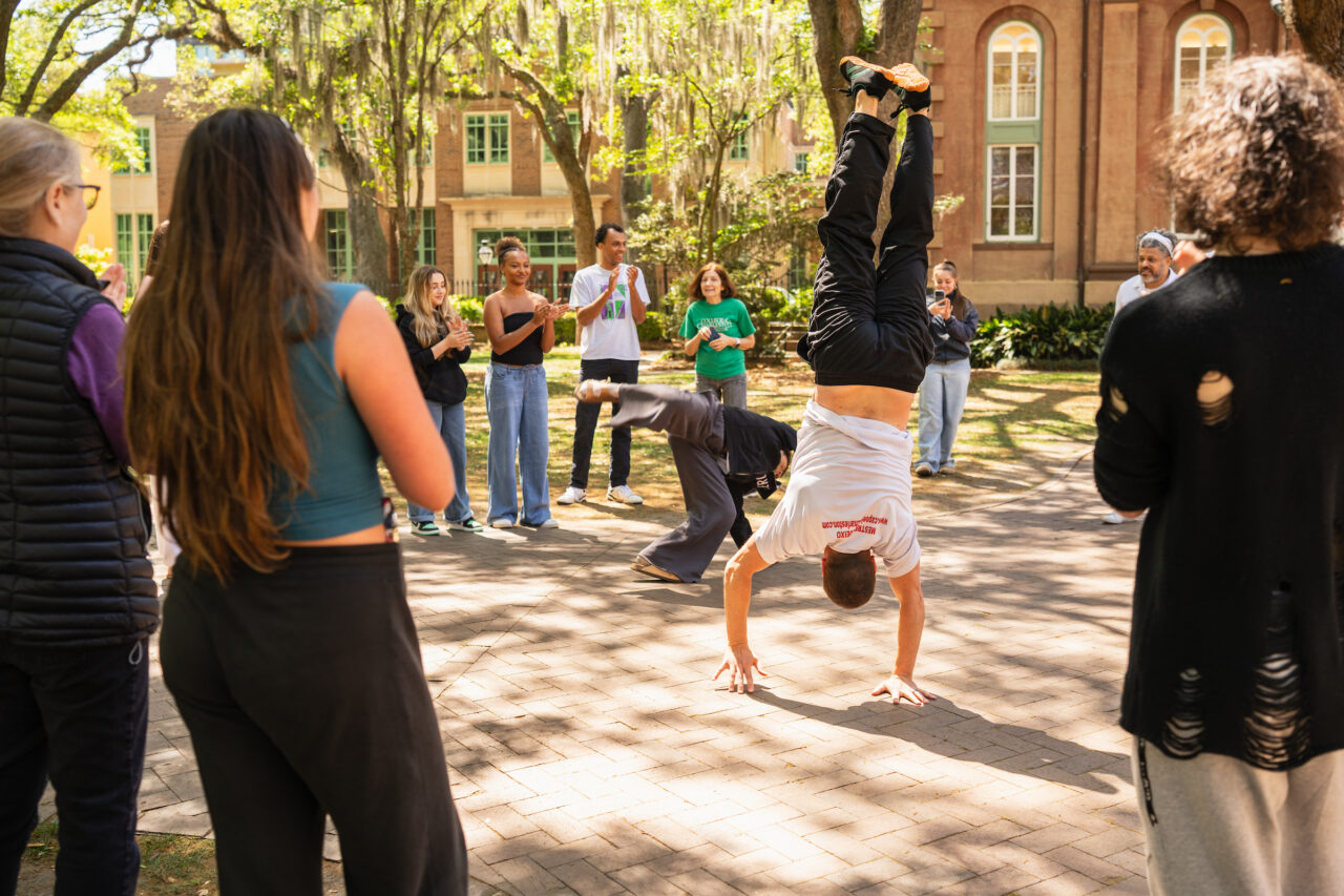 man upside down doing hand stand