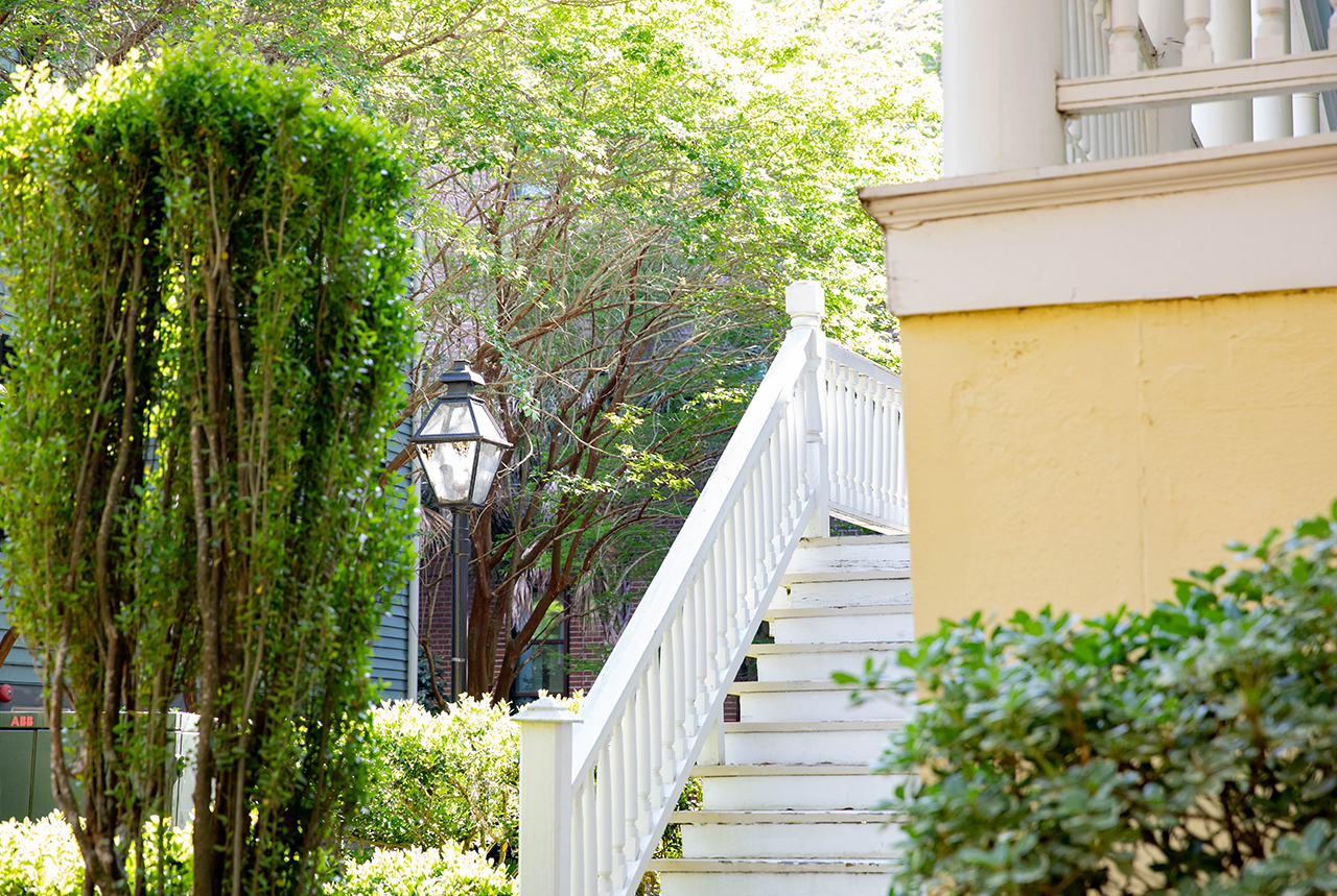 photo of yellow building with white steps 