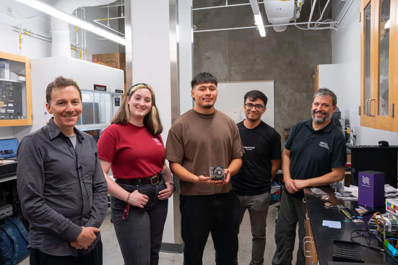 Students, faculty and NASA reps pose for photo with payload