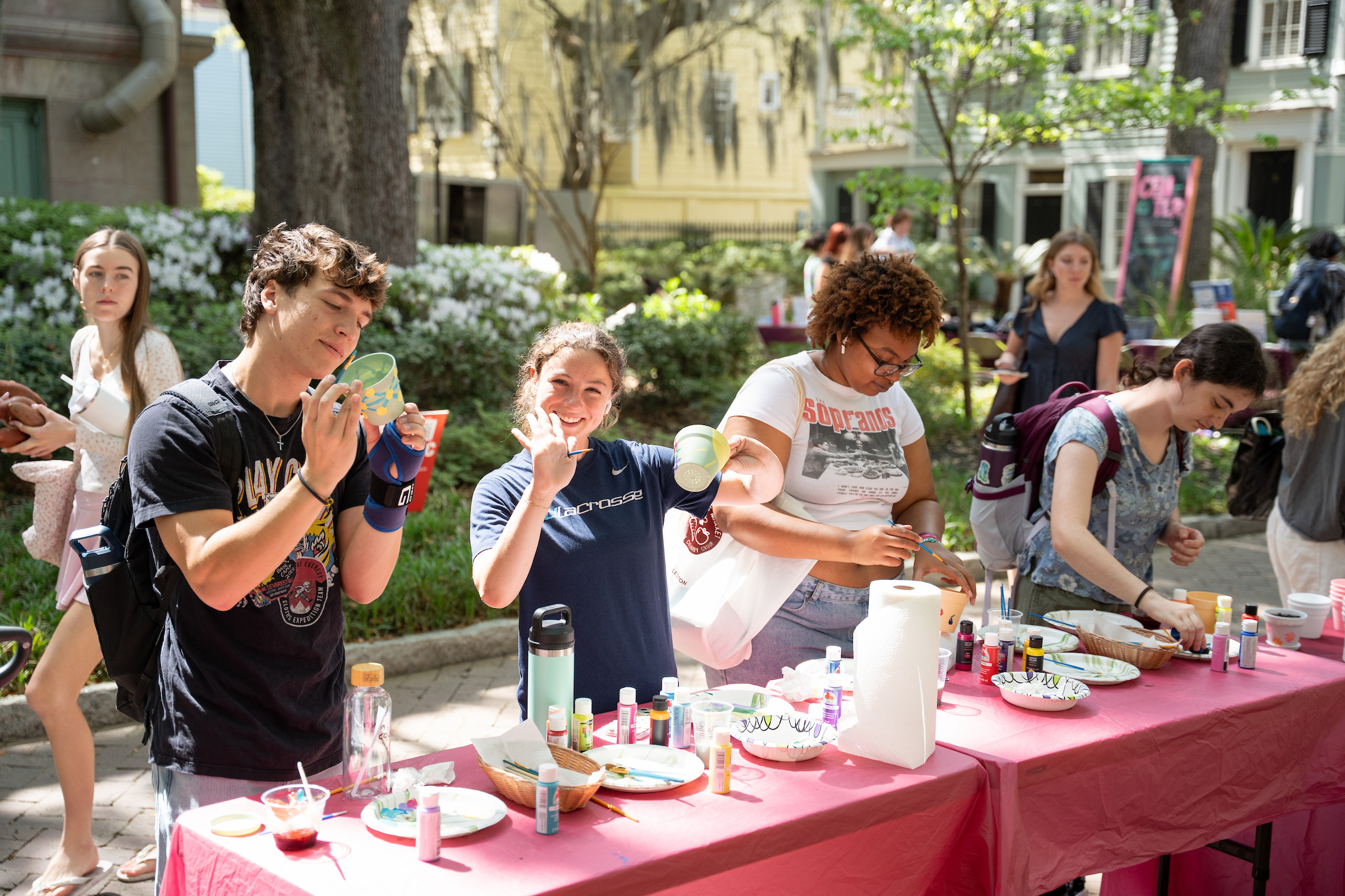 student waves at camera