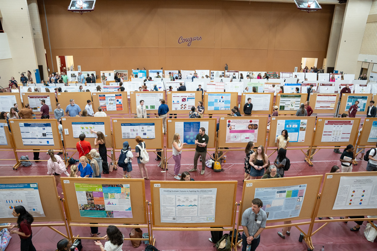 wide photo of EXPO posters in gym