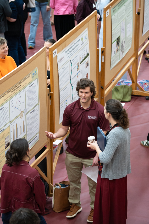 student talks with hands about research