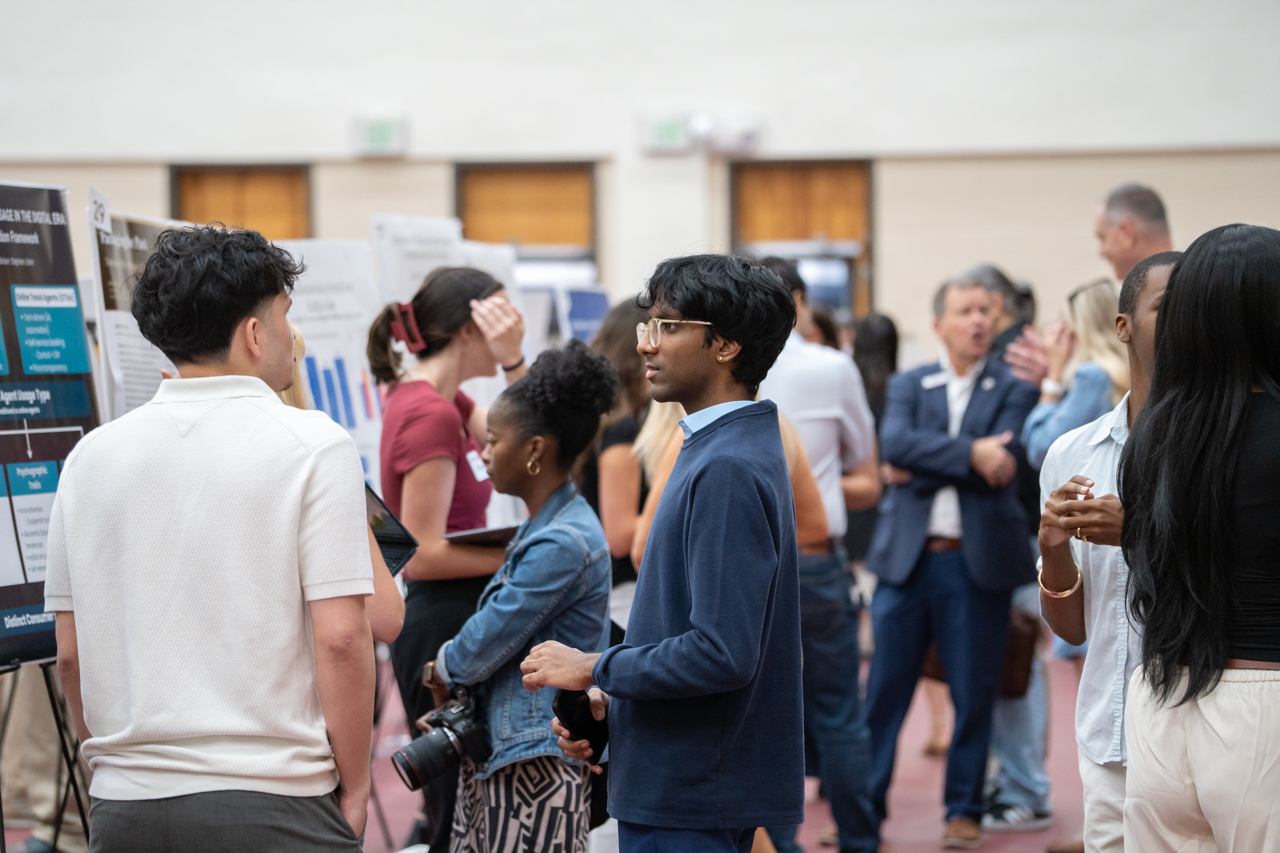 students look on research posters 
