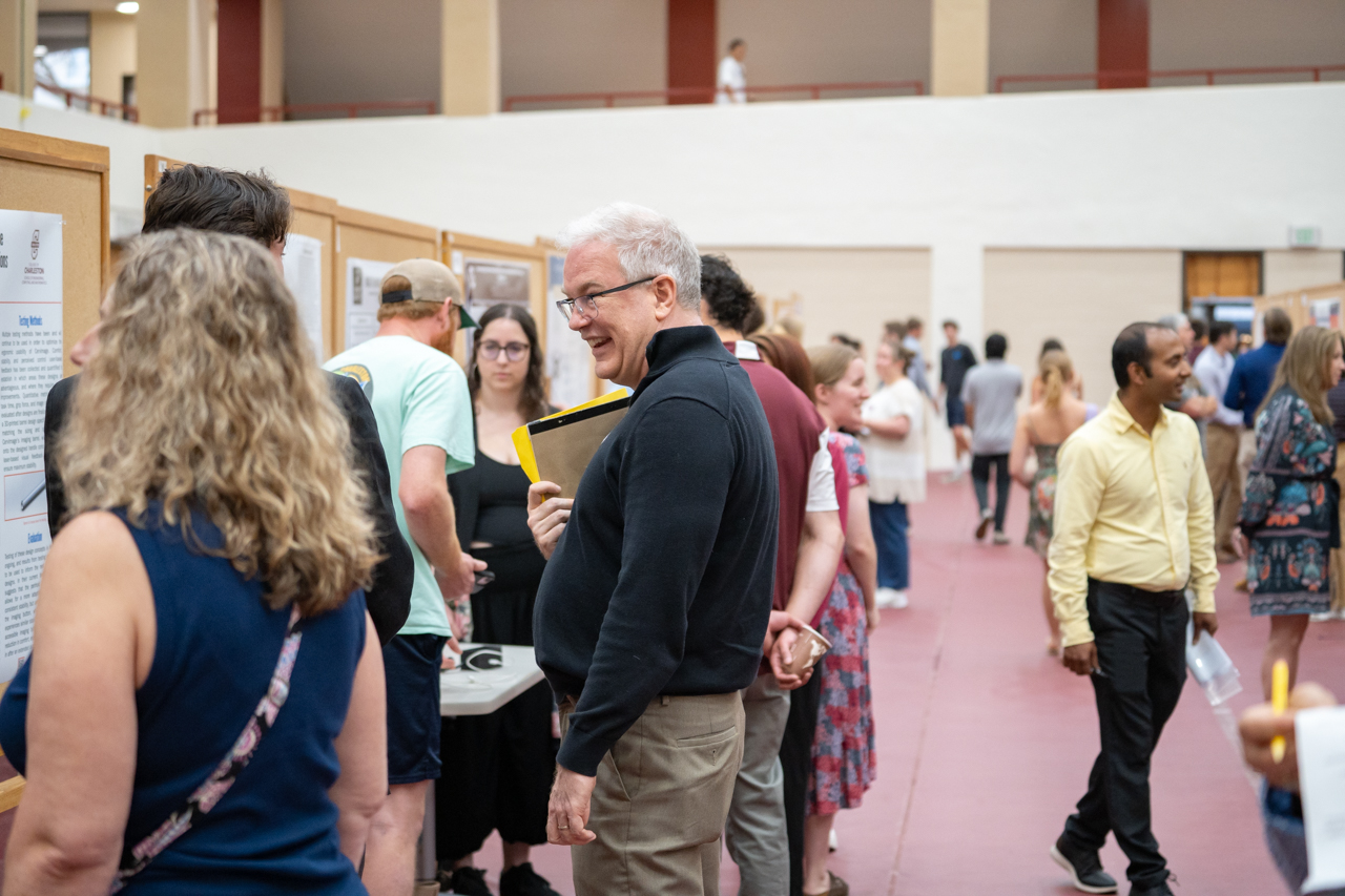 Faculty laughs and engages with students 