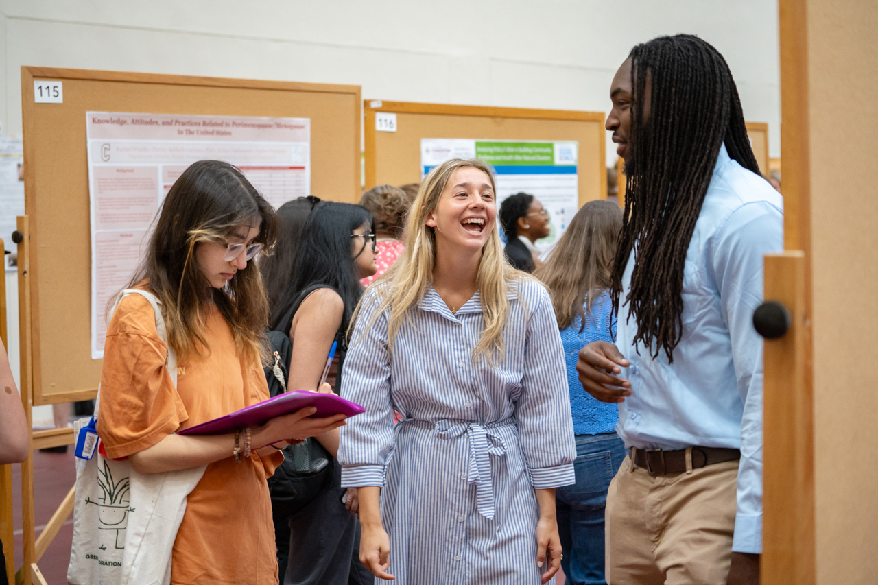 students laugh together at EXPO