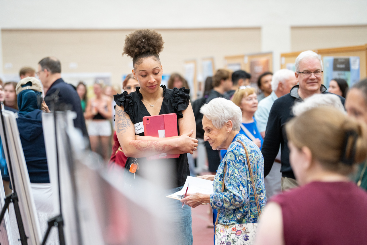 Young Student talks to older woman about research