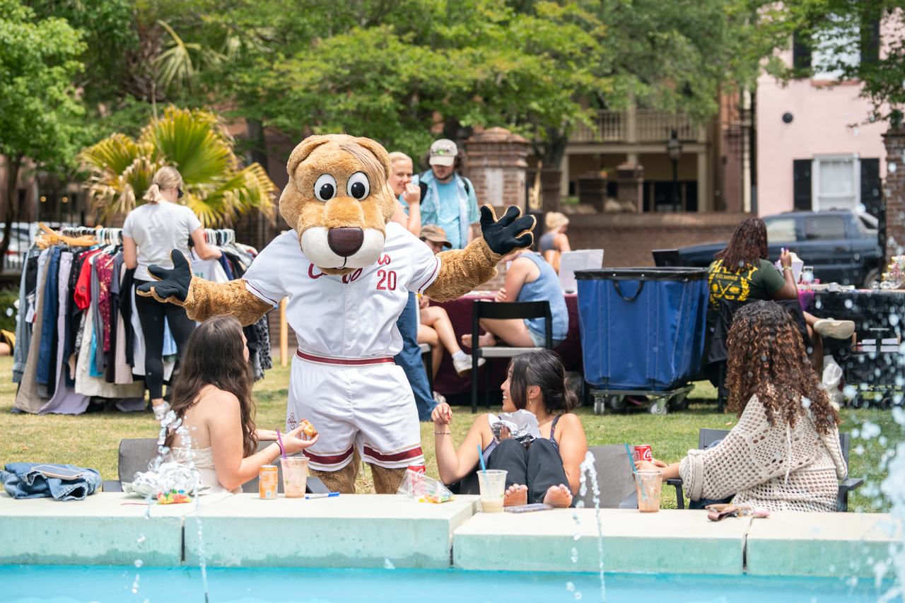 Clyde chats up students near a fountain