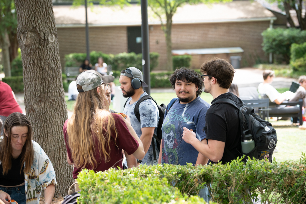 students talk at free food event
