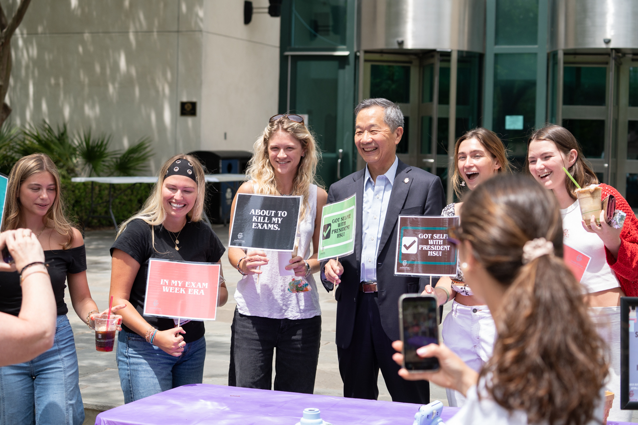 group takes photos with President Hsu