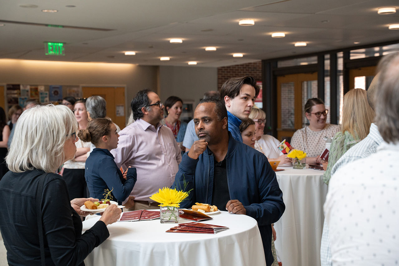 faculty member listens to another intently 