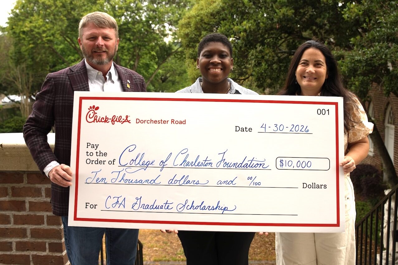 people holding a big check