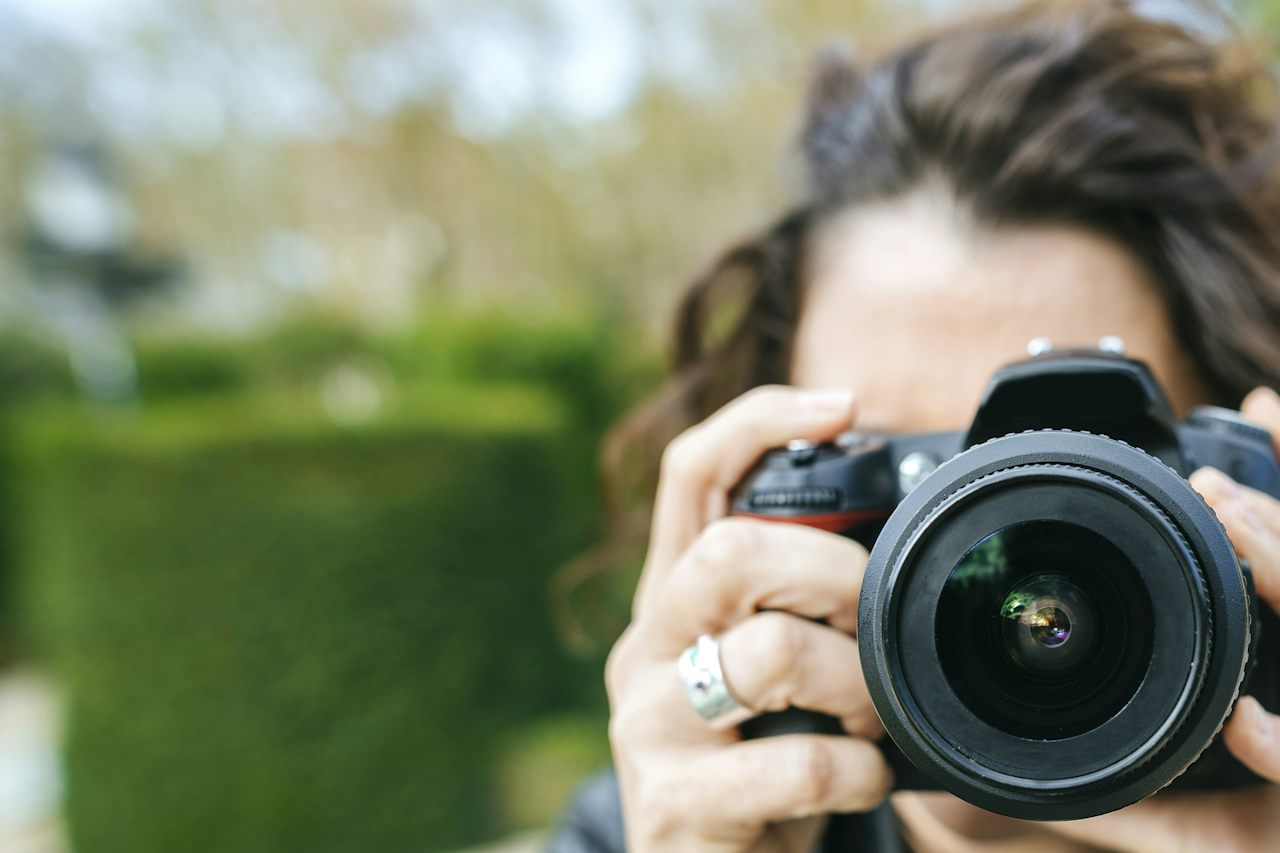 woman pointing a camera
