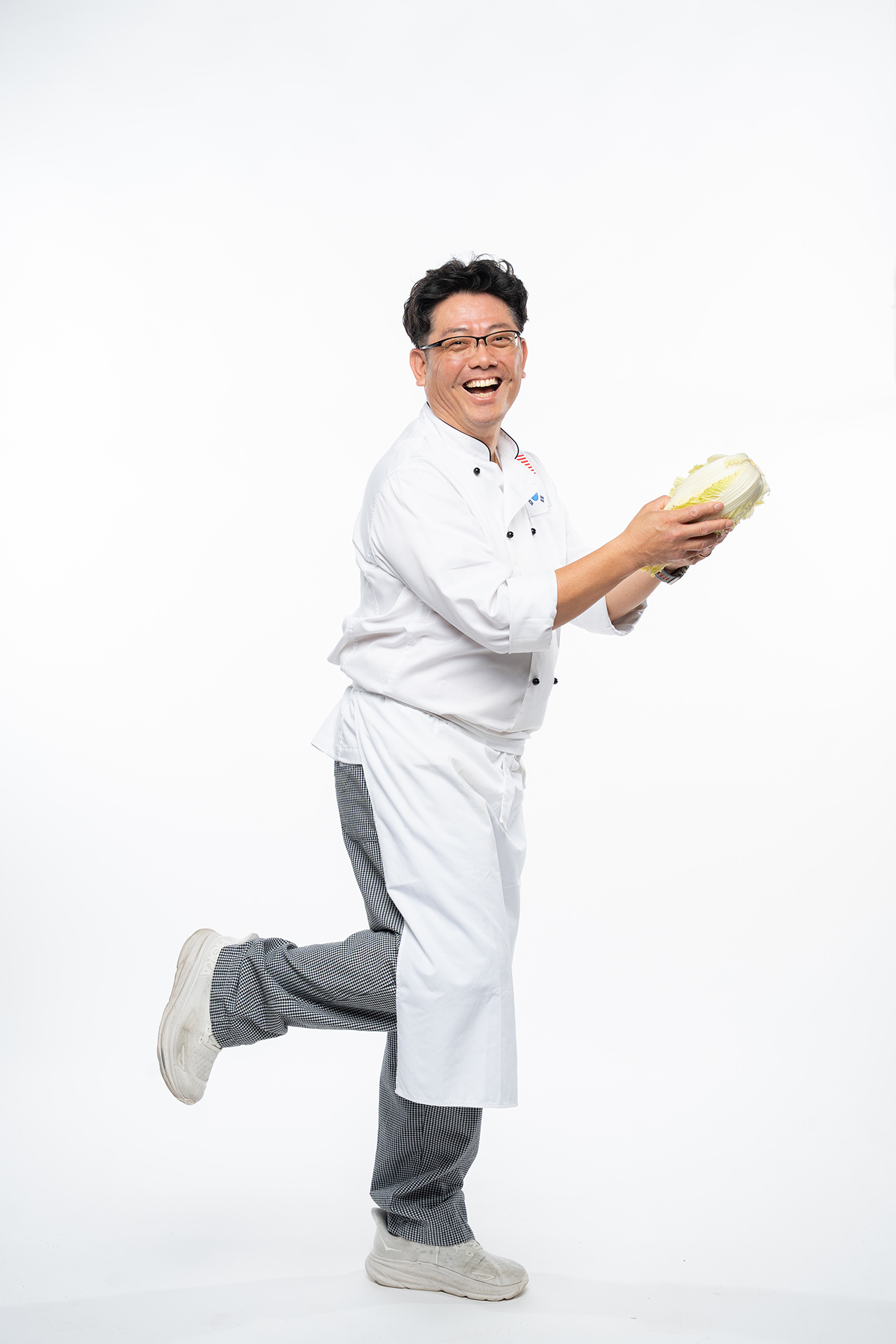 Hunter Kim in the studio running away with a loaf of bread in comedy