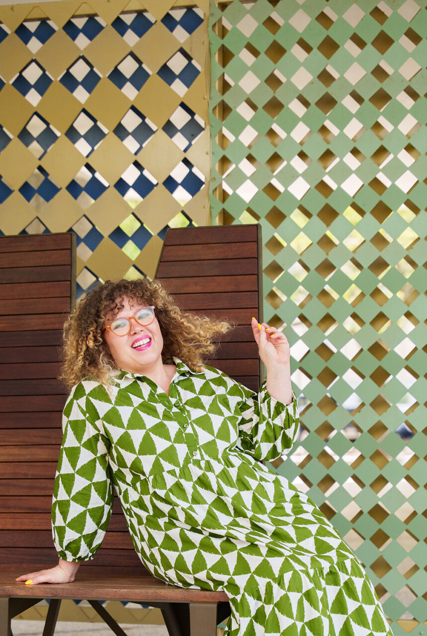 Dr. Alison H. Kibbe poses with green background that matches her dress