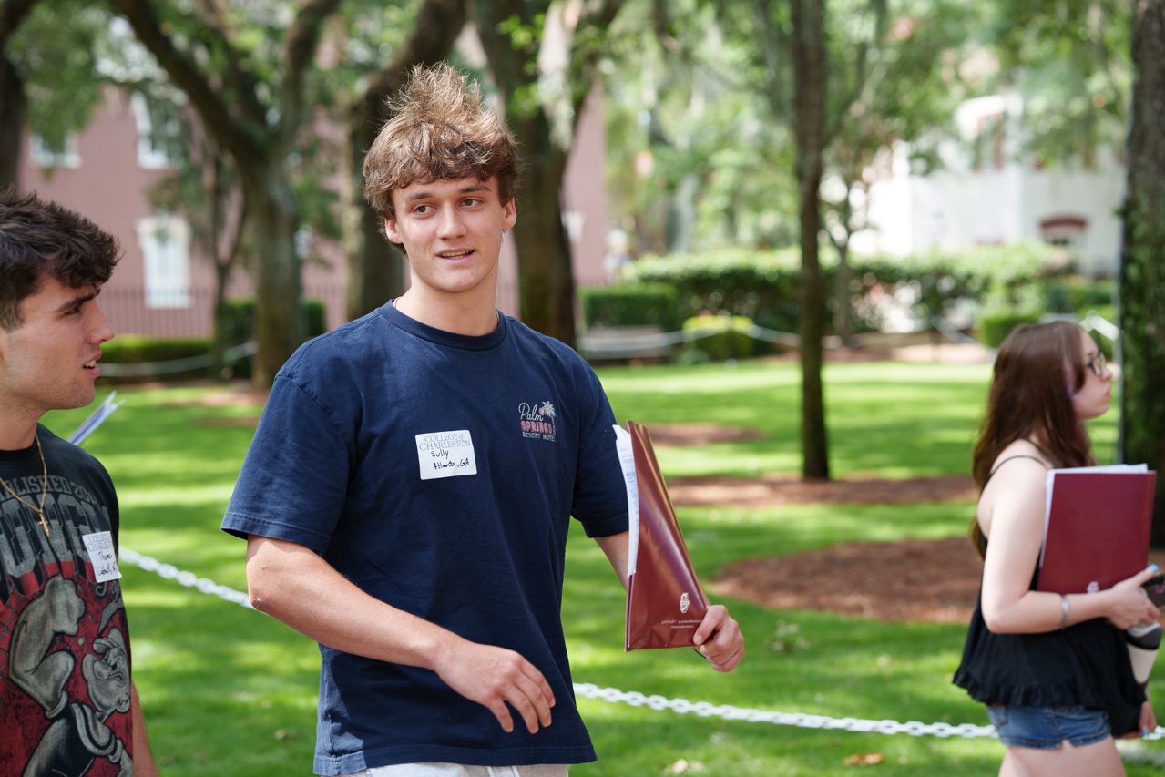 Male student walks and talks with another New Student