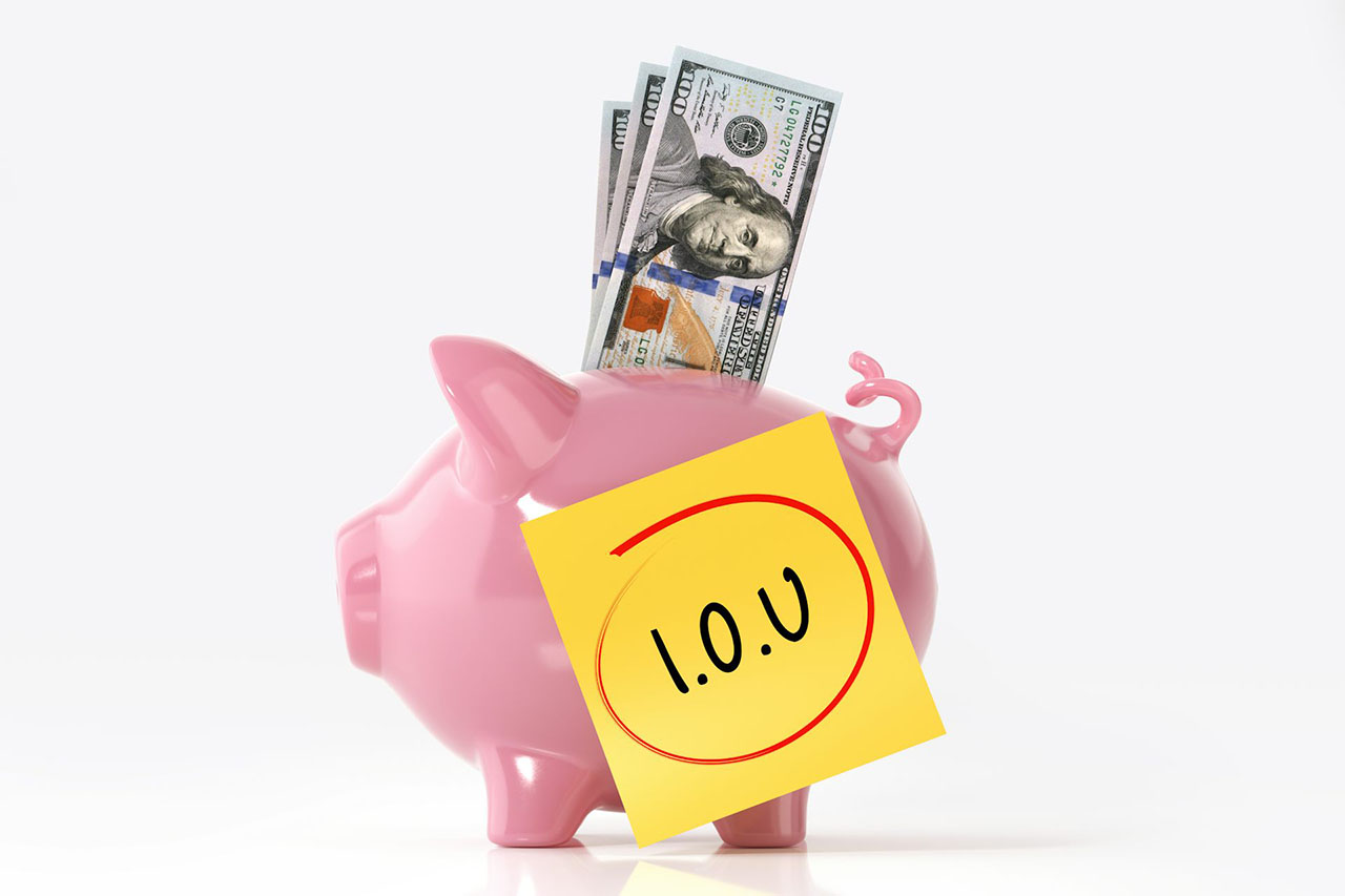 piggy bank with IOU note