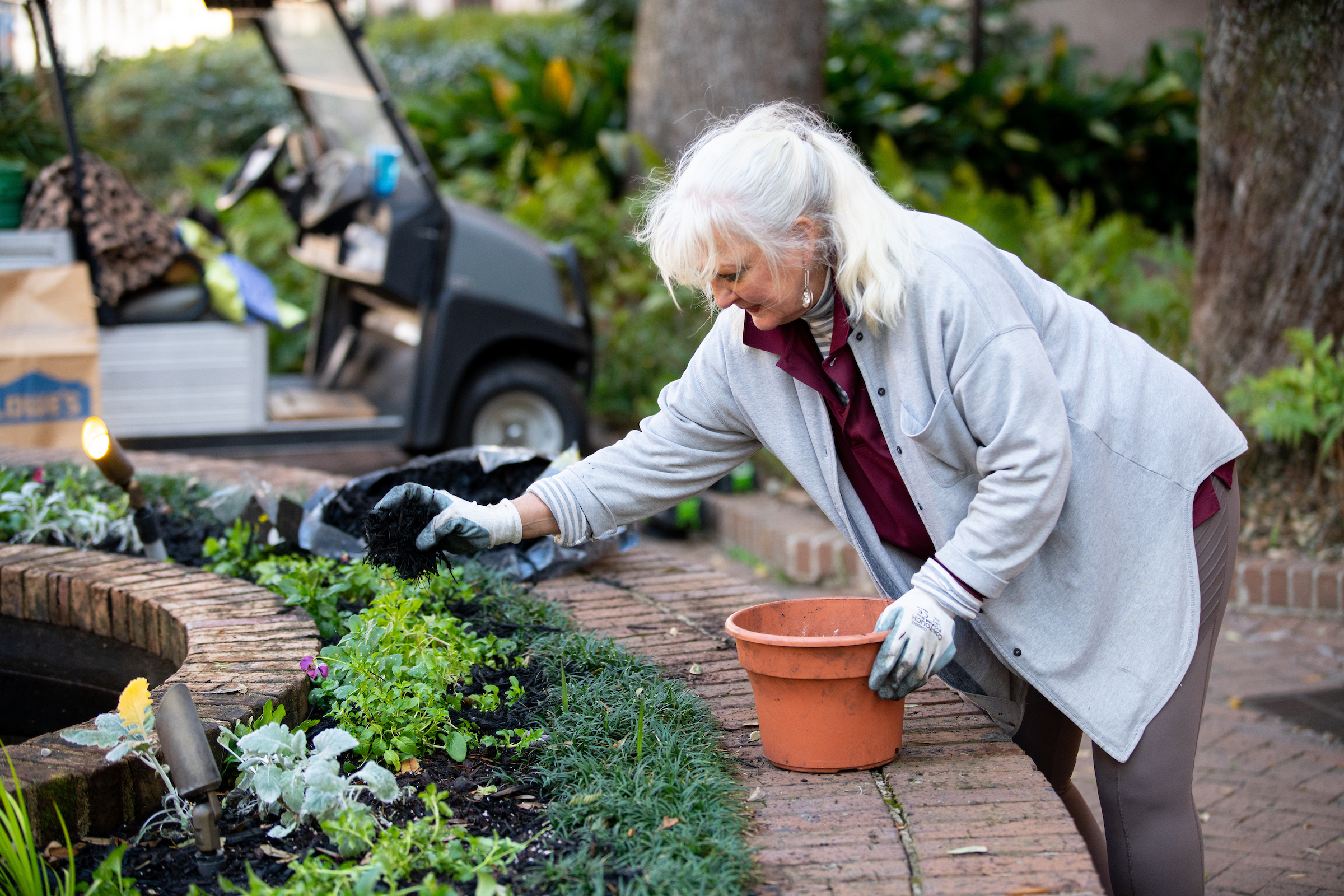 Becca Hodges, grounds, planting flowers at the fountain