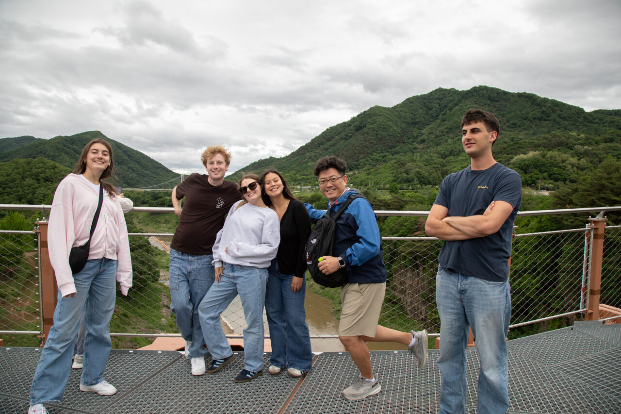 Students together with their professor in Sourth Korea on bridge