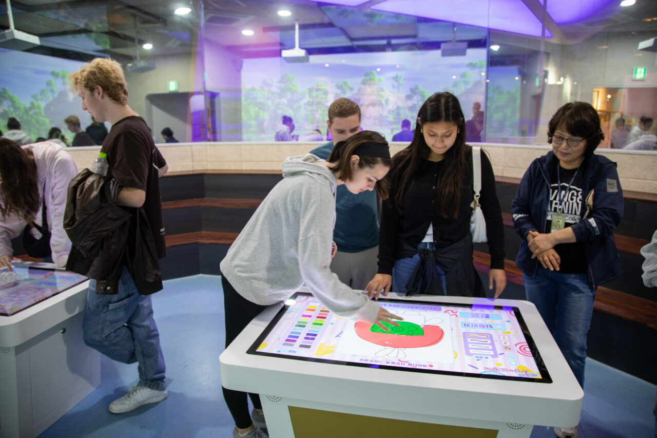 Students interacting with exhibit in South Korea Museum