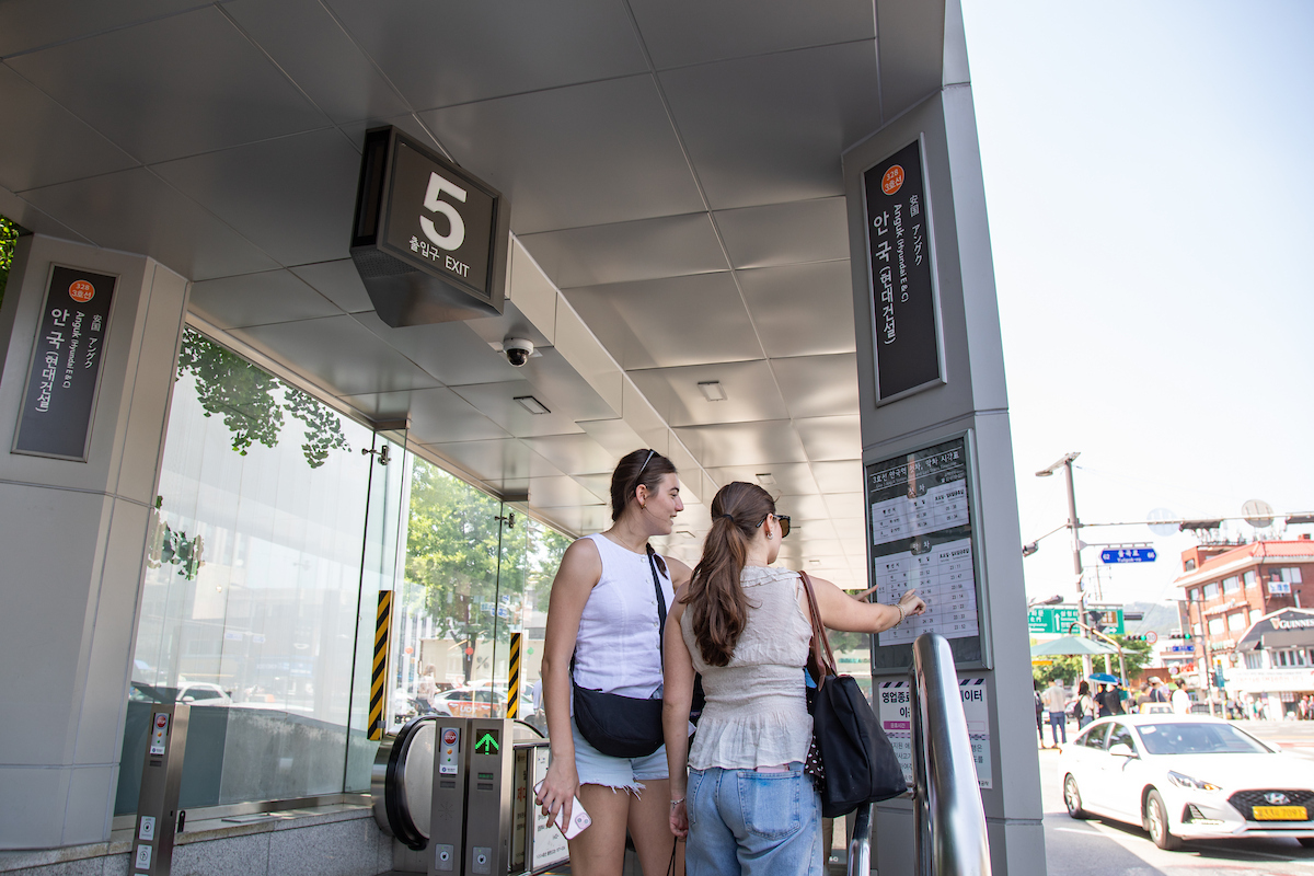 Students reading public transportation map in South Korea
