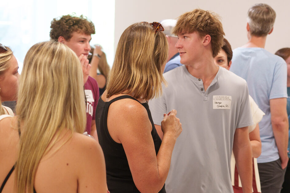 Male student smiles at friend at orientation