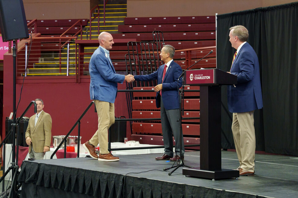 Wes Dugen walks across the stage for 10 year award